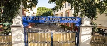 Building of St. John’s High School, Hebbal with a blue signboard displaying the school’s name
