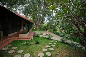 A picturesque view of The Valley School building nestled amidst lush greenery, with a serene natural landscape creating a tranquil atmosphere.